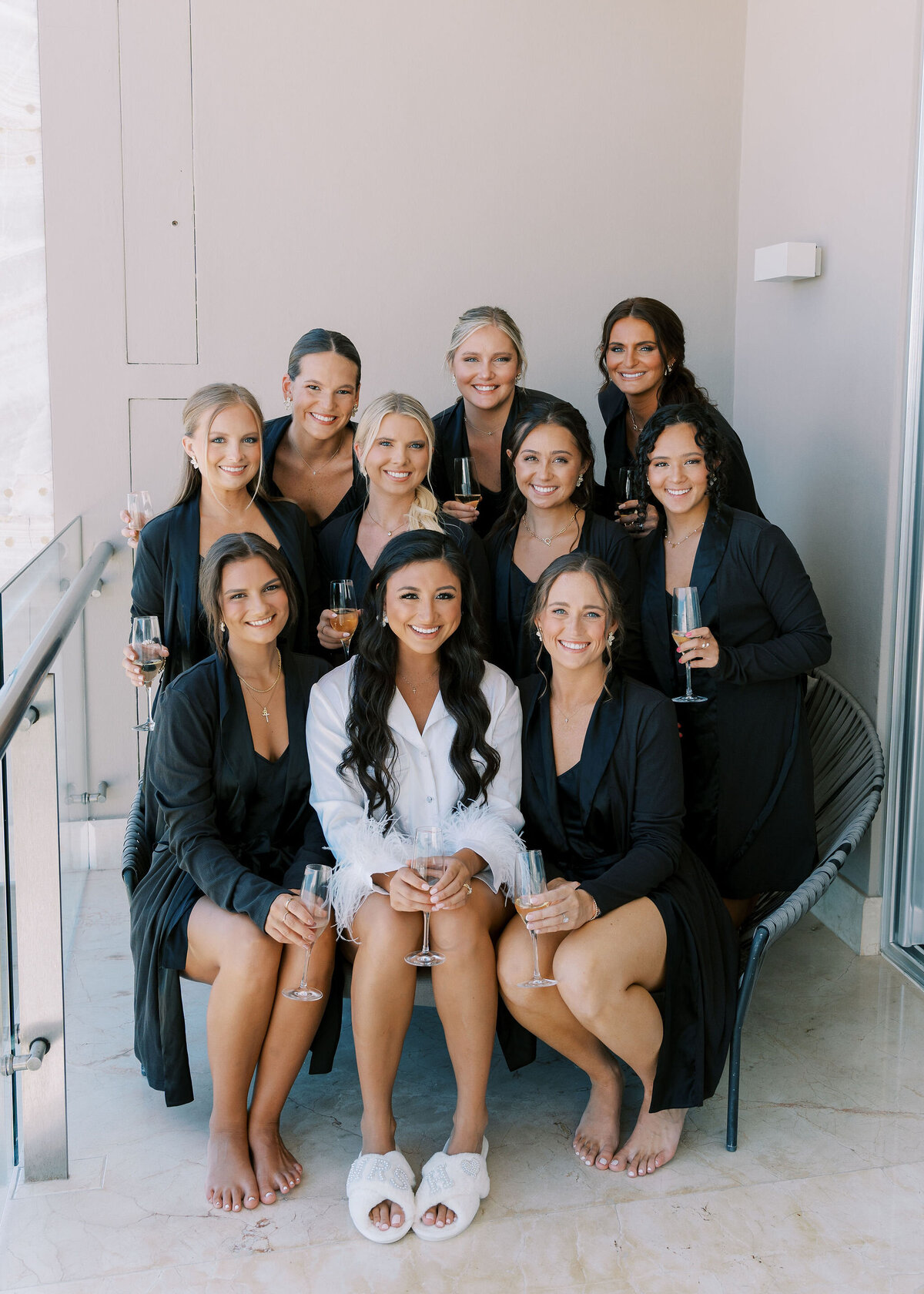 a bride and her bridesmaids wearing robes