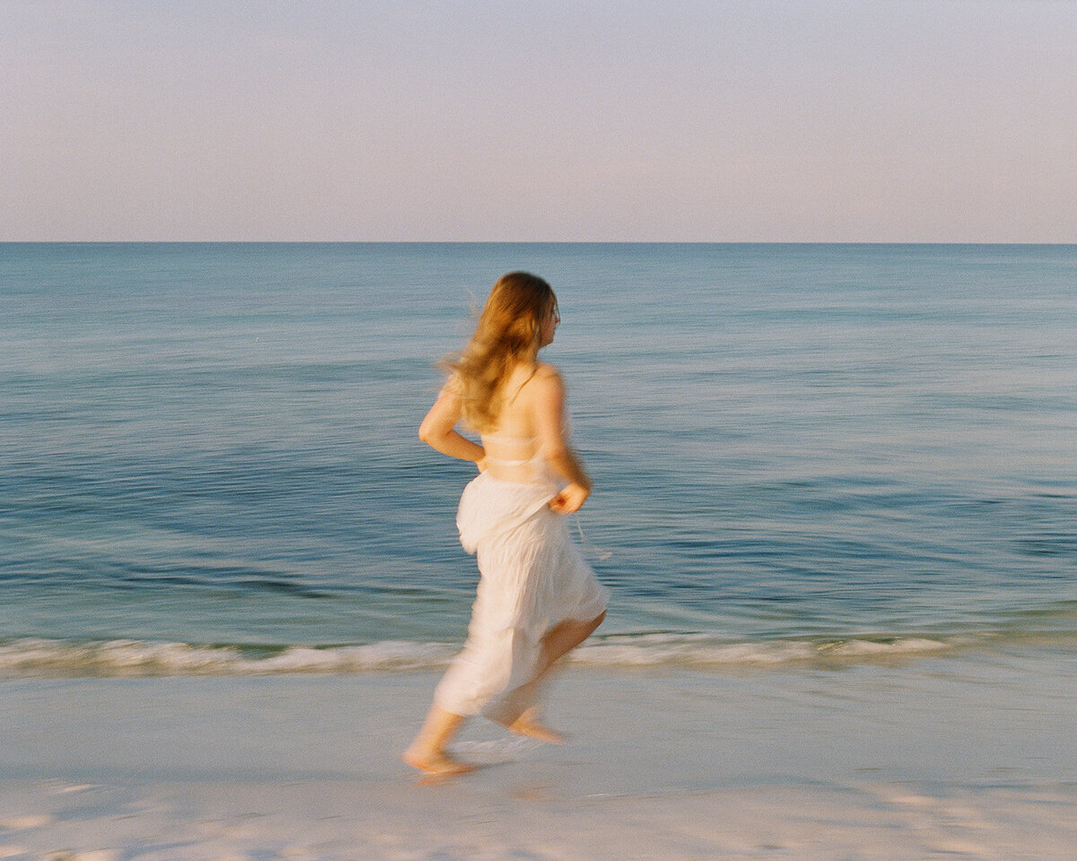 Girl running on the beach in 30A Florida