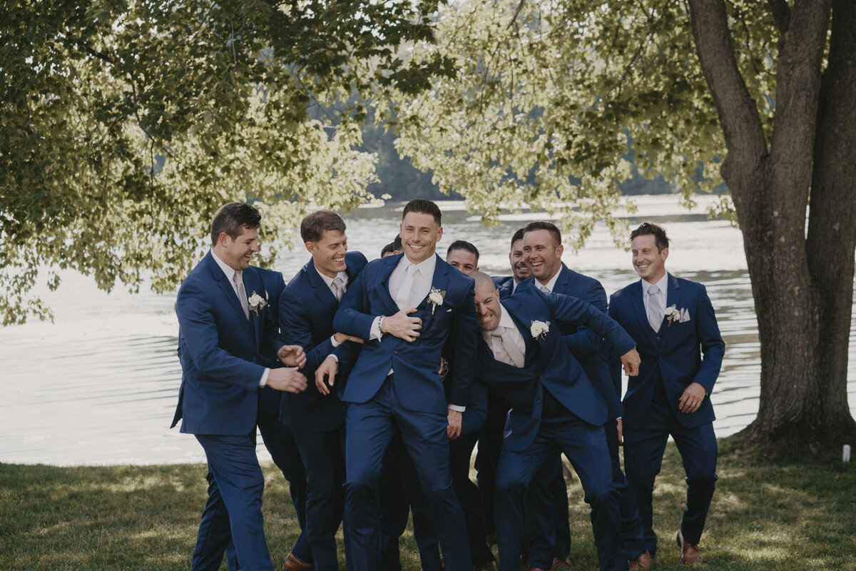 Groomsmen carrying the groom