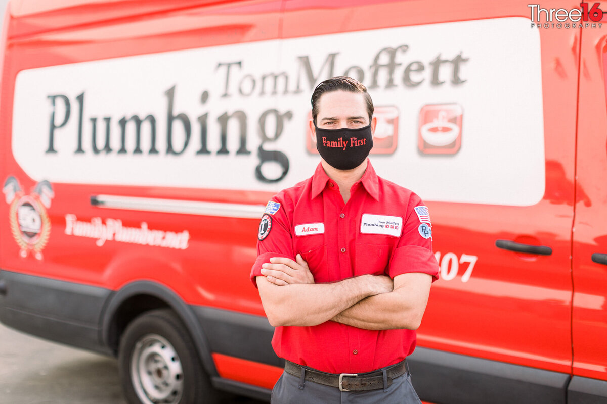 Plumber poses for headshot photo wearing a mask