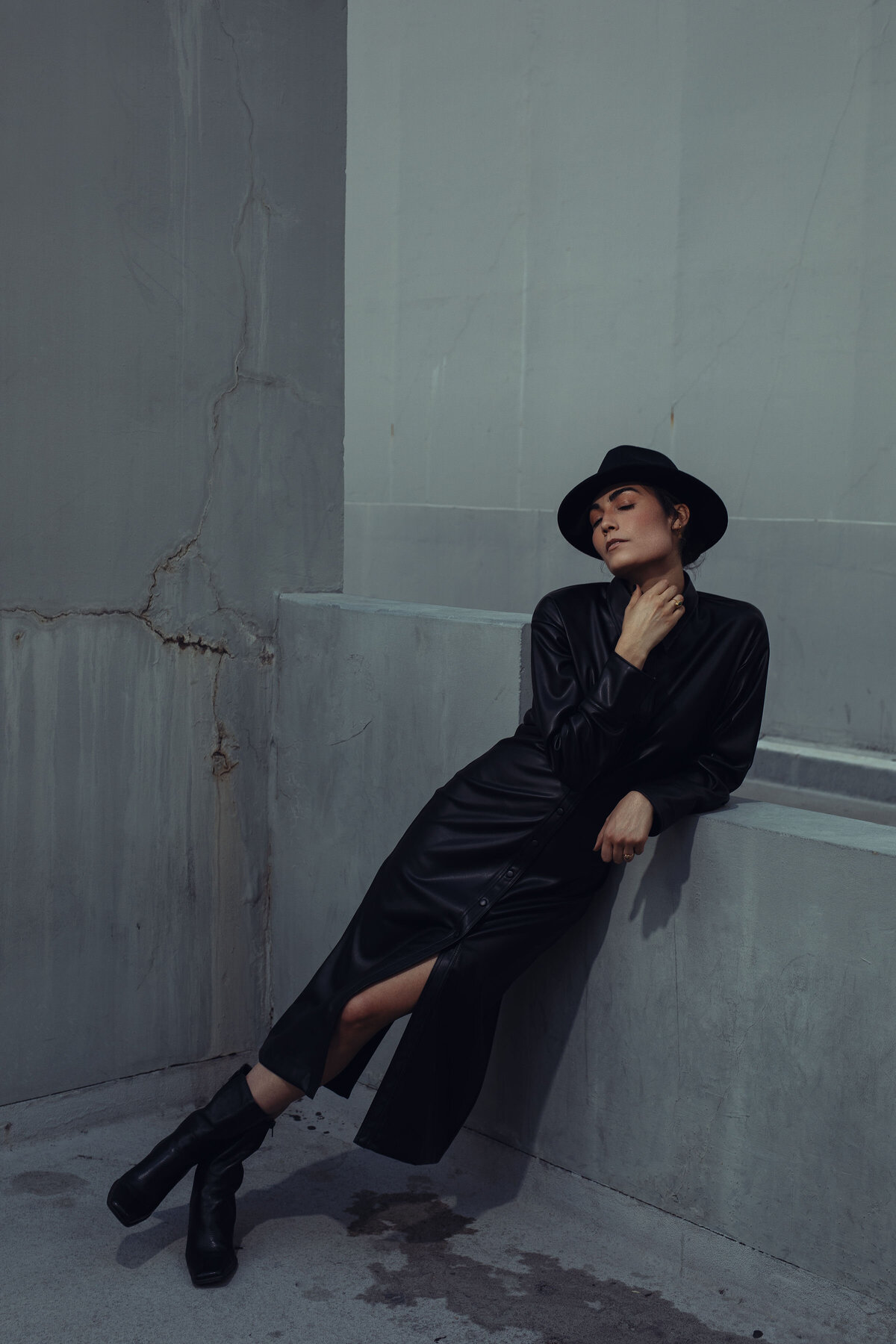 Portrait Photo Of Young Woman In Black Coat Touching Her Neck Los Angeles