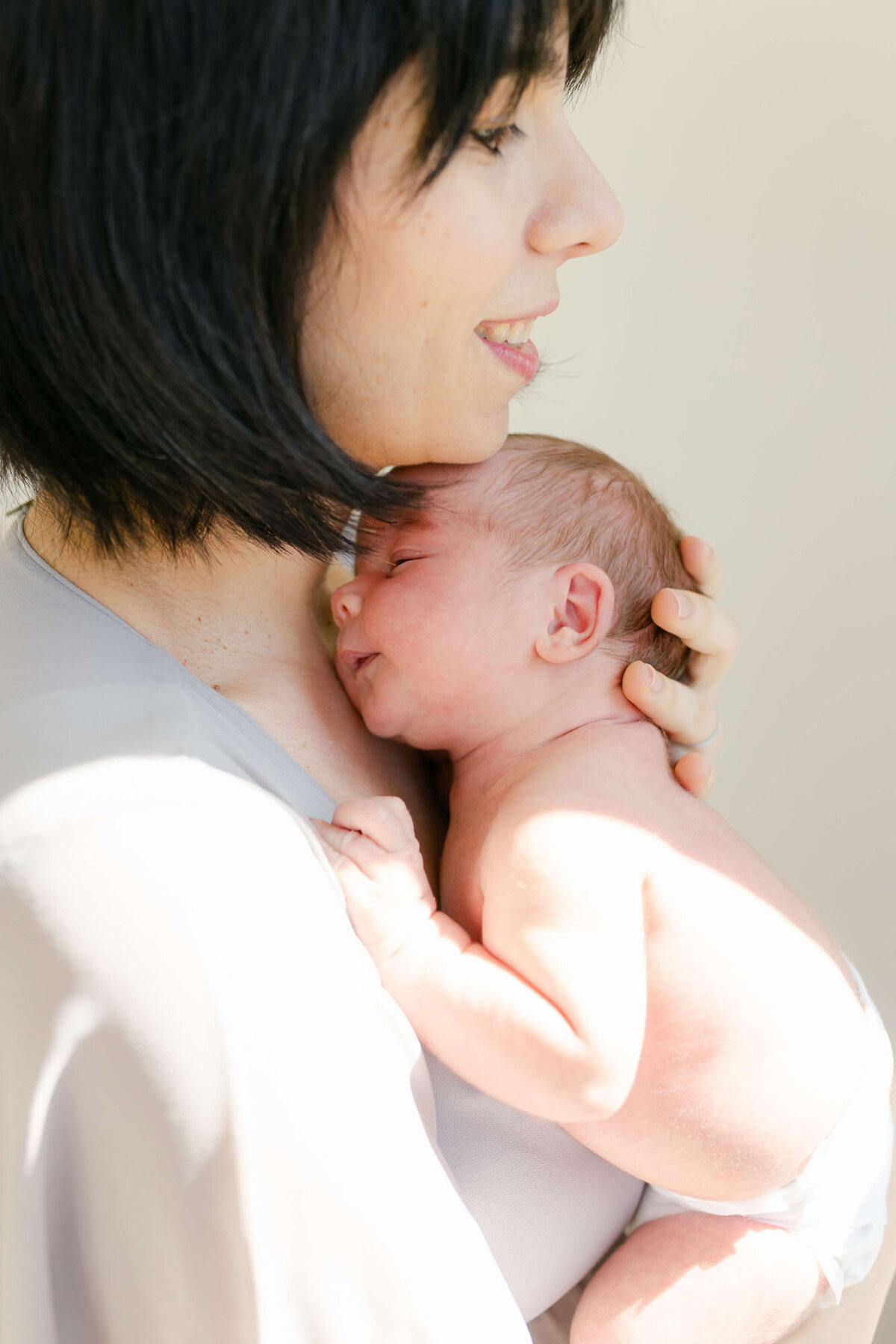 Tender moment of parents and baby in bedroom, Bay Area newborn family photography.
