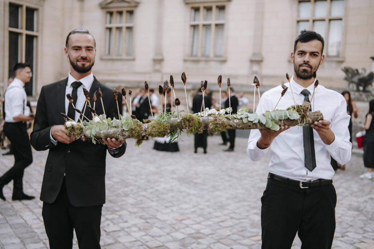 Paris Destination Wedding at Chateau de Chantilly by Alejandra Poupel Events horizontal waiters holding a big platter