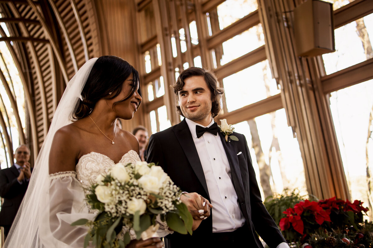 walking back down the isle, bride and groom share a look