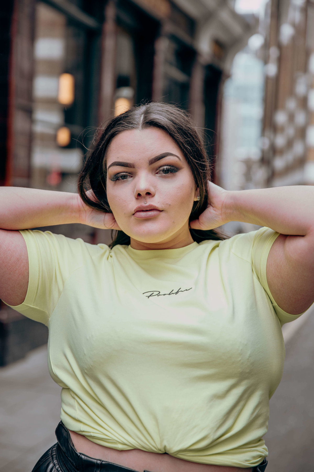 Tia wearing a neon t shirt, posing on the street in Shoreditch