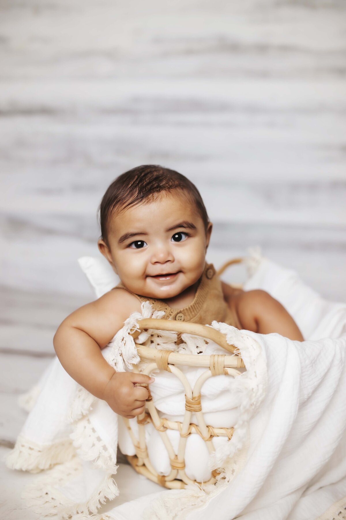 Personality session of baby in basket at studio located in Ozark Missouri
