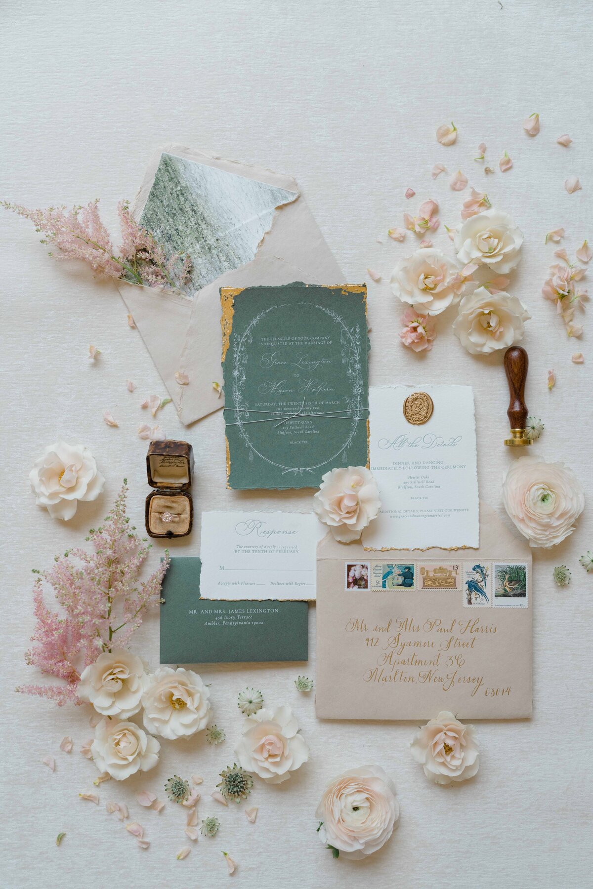 a custom stationary invitation suite surrounded by flowers