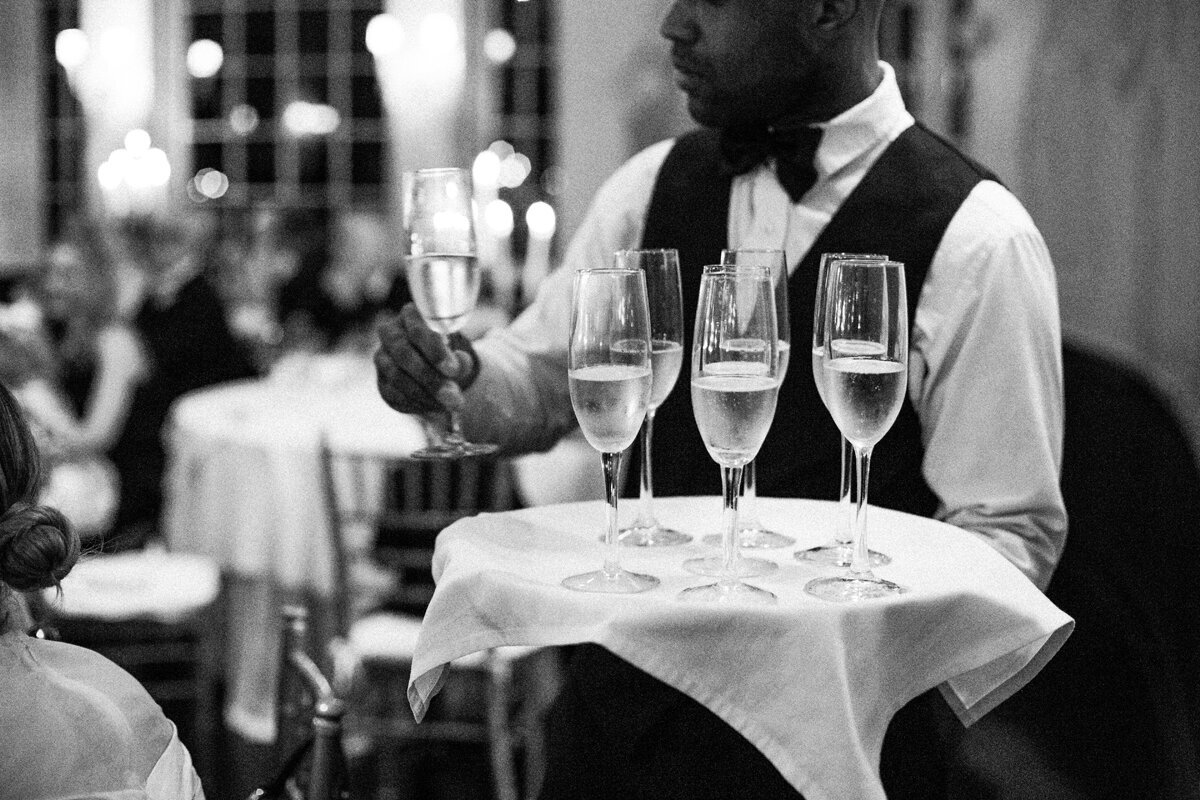 Waiter hands out champagne at wedding