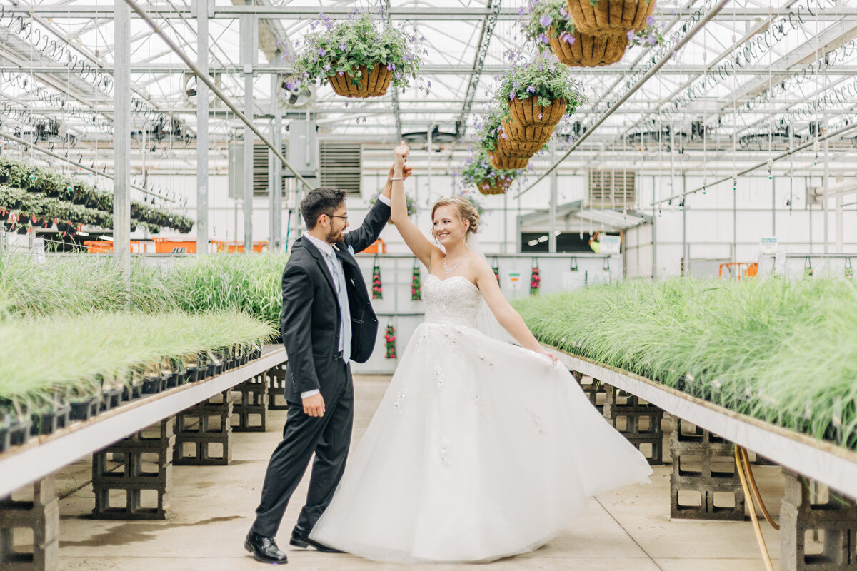 bride and groom dancing in greenhouse