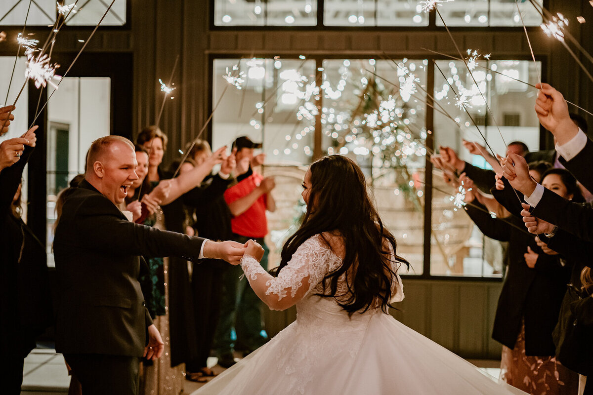 wedding-sparkler-exit-joyful-couple-ashton-hill-farm-cedar-rapids-iowa-storyteller-collective-photo-co