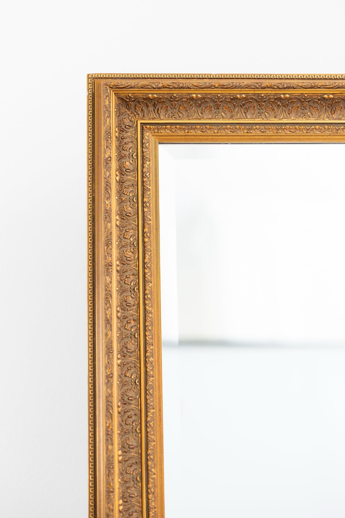Medium gold mirror with ornate border 