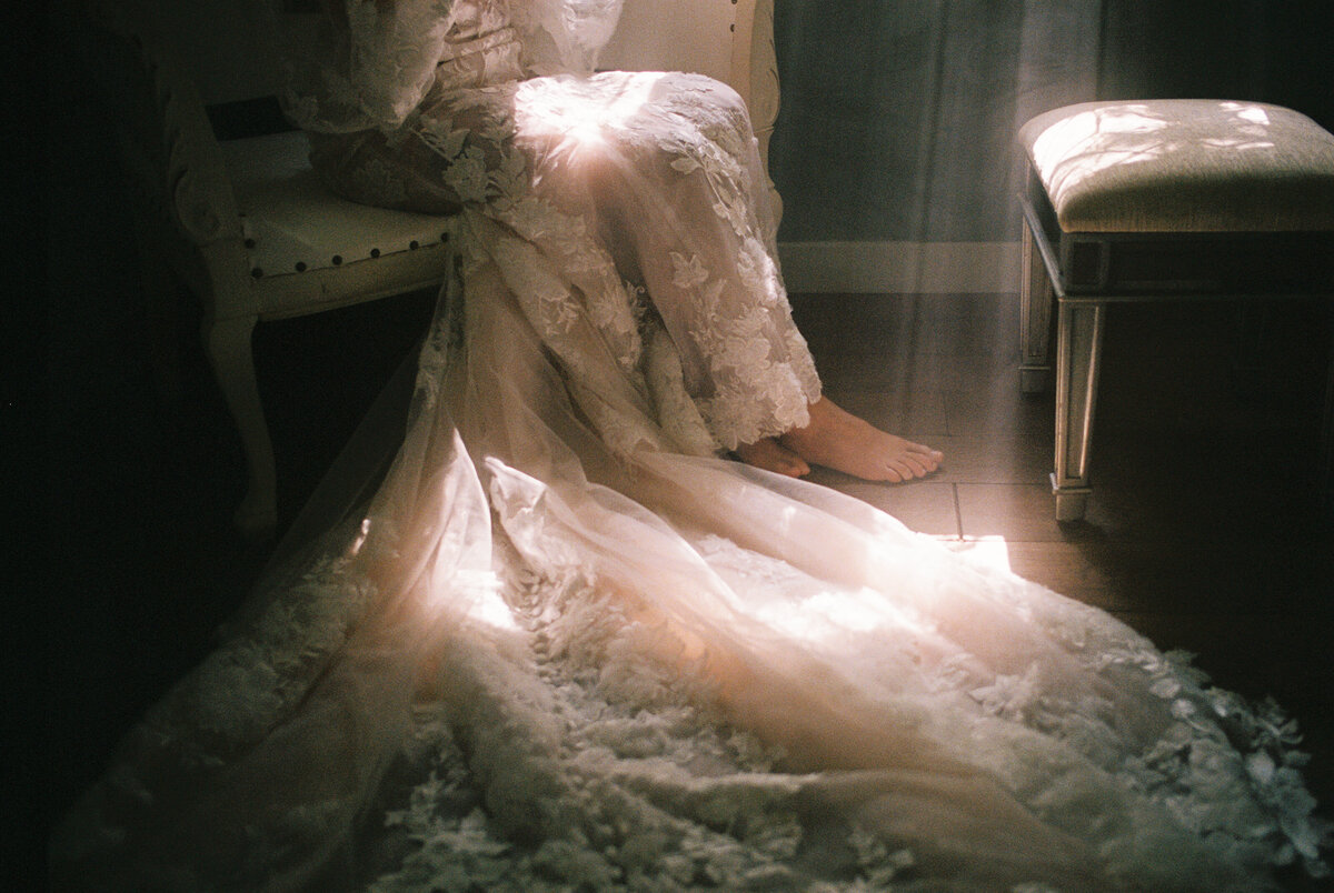 a bride's wedding dress in the sun