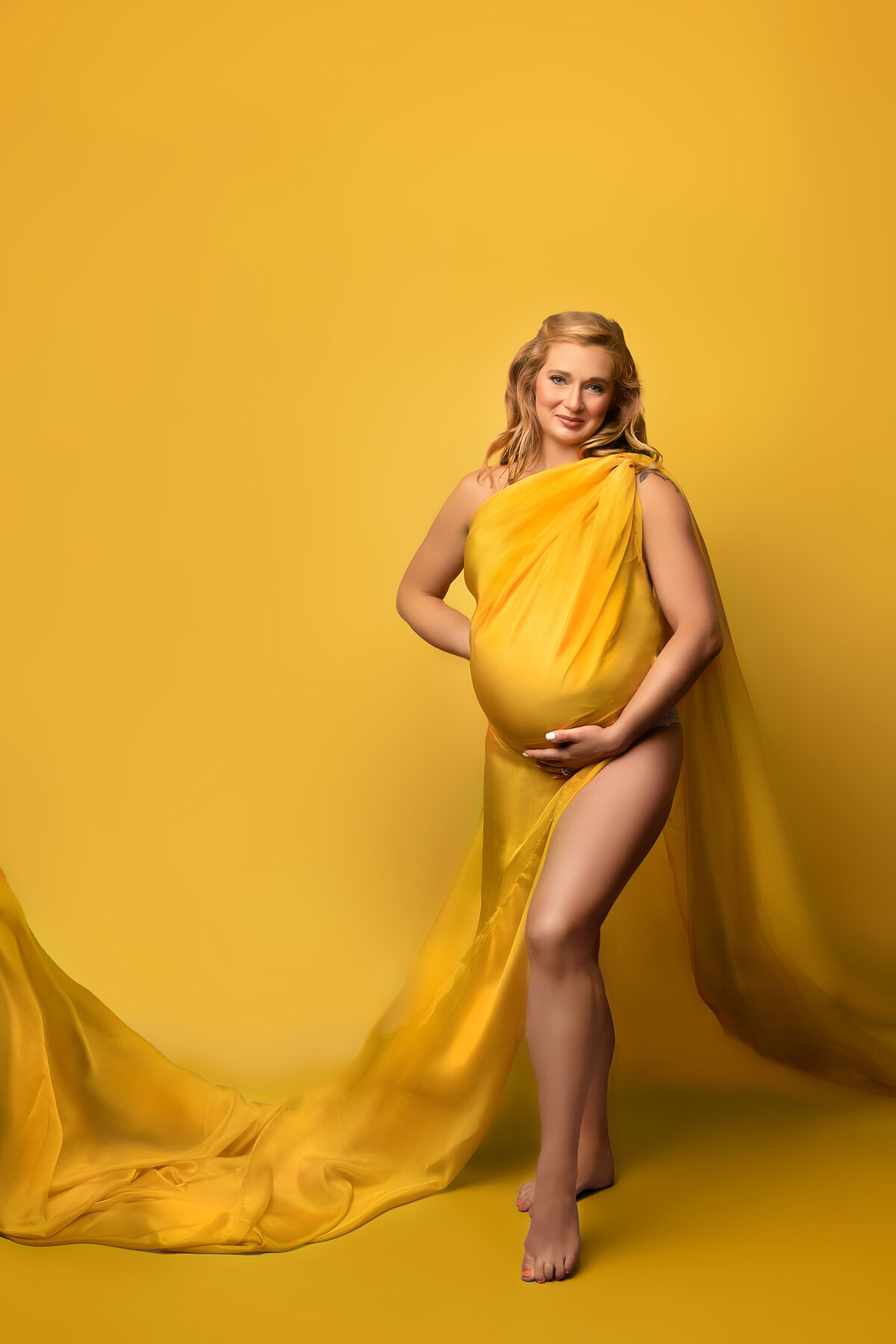 Yellow pregnant belly woman blonde fabric studio maternity