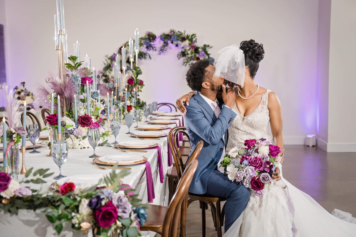 Romantic sweetheart table adorned with lush floral arrangements at a luxury wedding reception.