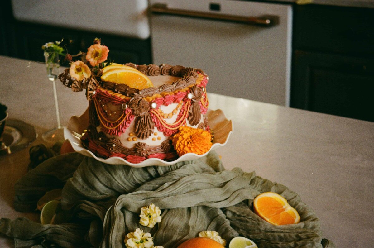 A decorated cake sits on a table during a Colorado Elopement.