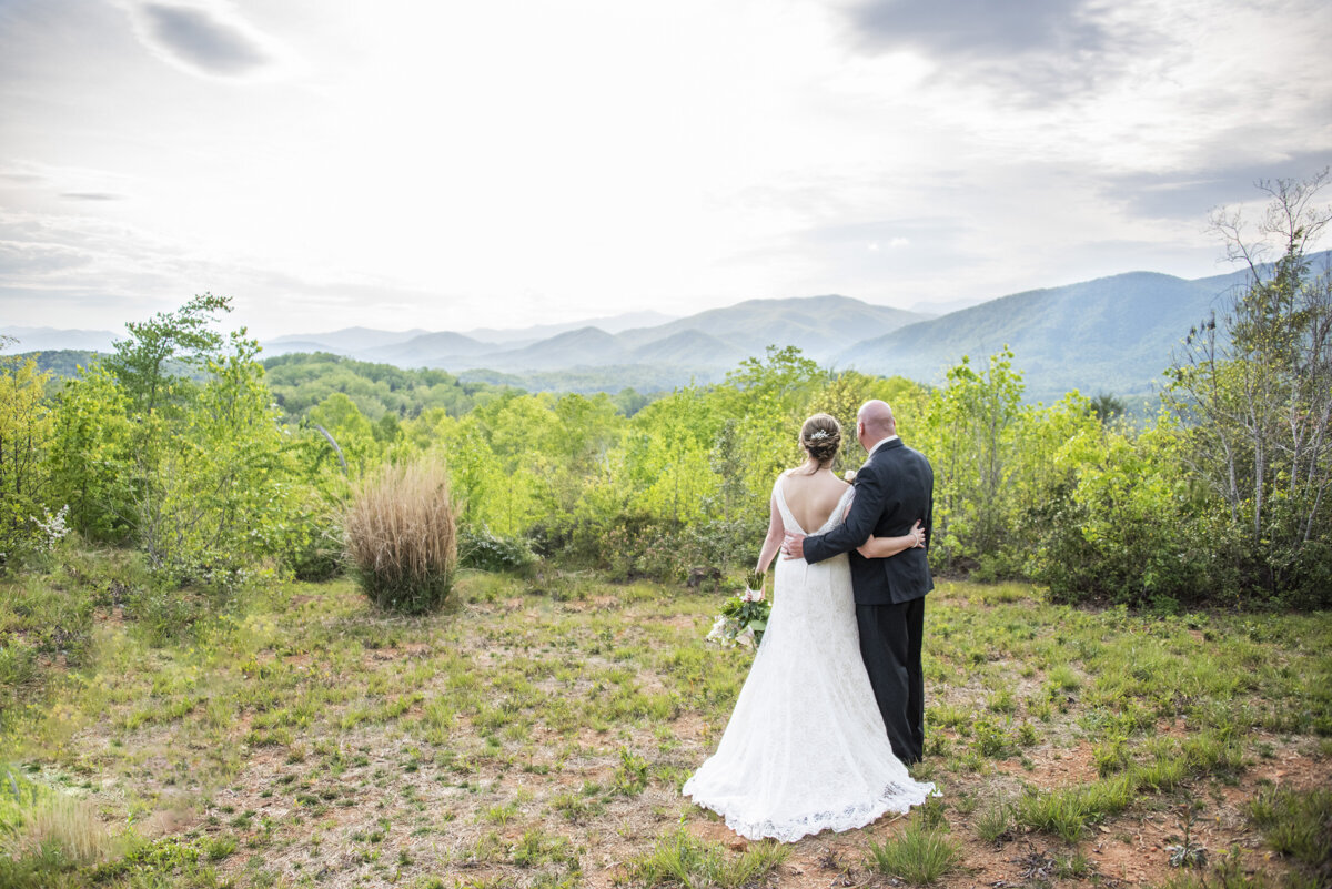 Couple looking at mountains after wedding at Something Blue wedding venue
