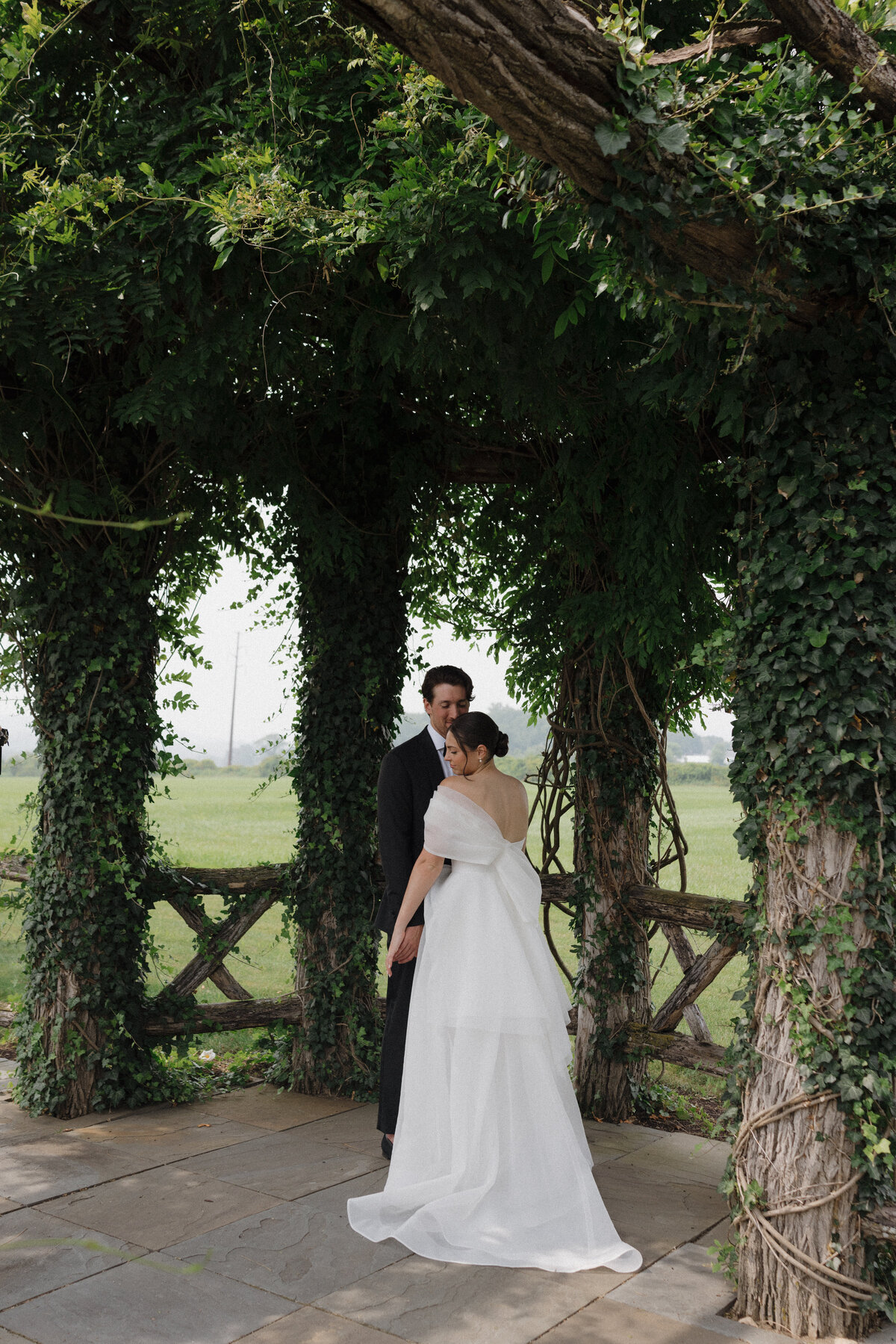 Elegant editorial couple portrait showcasing sophisticated wedding photography at Connecticut luxury destination venue. NYC photographer Lauren Alatriste captures fashion photography composition while maintaining authentic emotional connection, creating imagery that transcends traditional documentation.