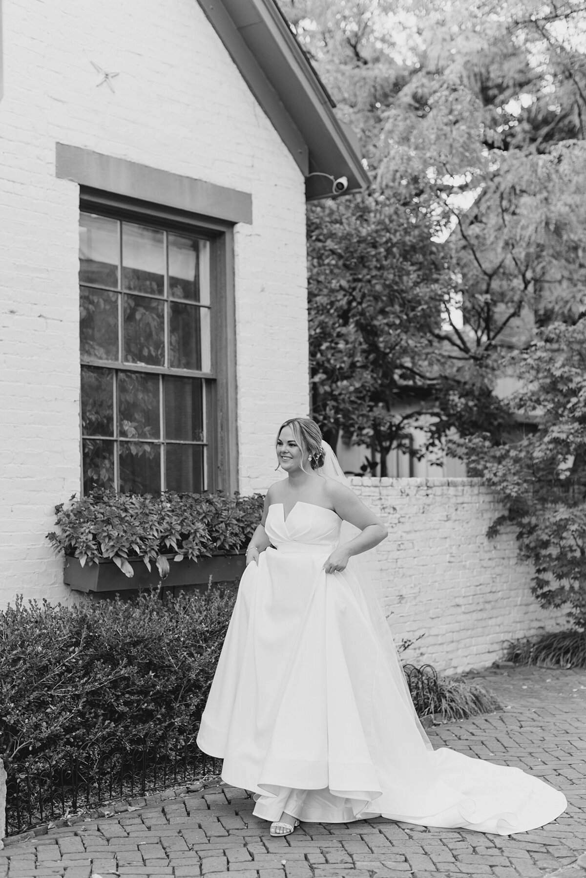 Bride runs down the sidewalk holding dress photographed by Columbus, Ohio Wedding Photographers