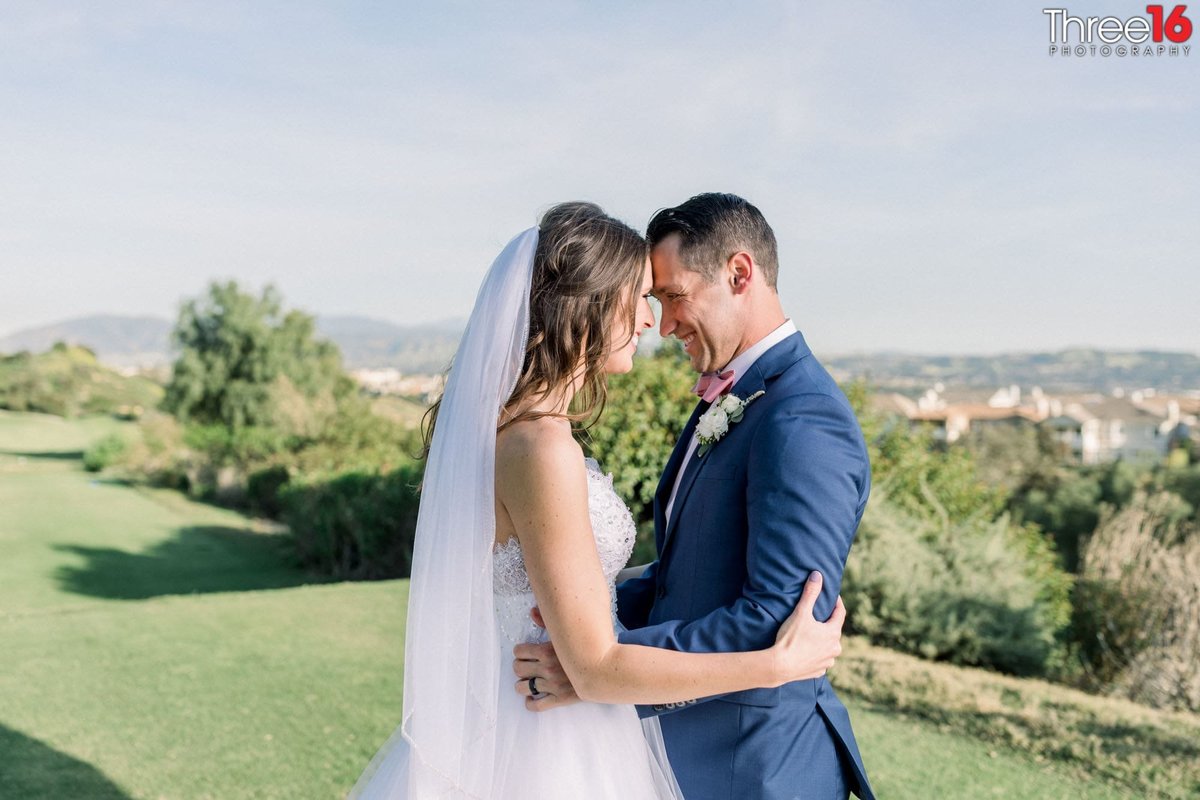 Bride and Groom share a tender moment overlooking the city