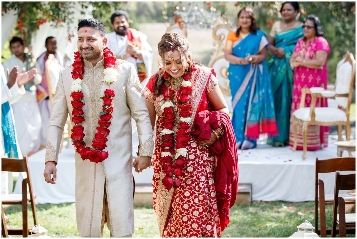 Austin wedding photographer pecan springs ranch wedding photographer bride groom leaving ceremony Indian