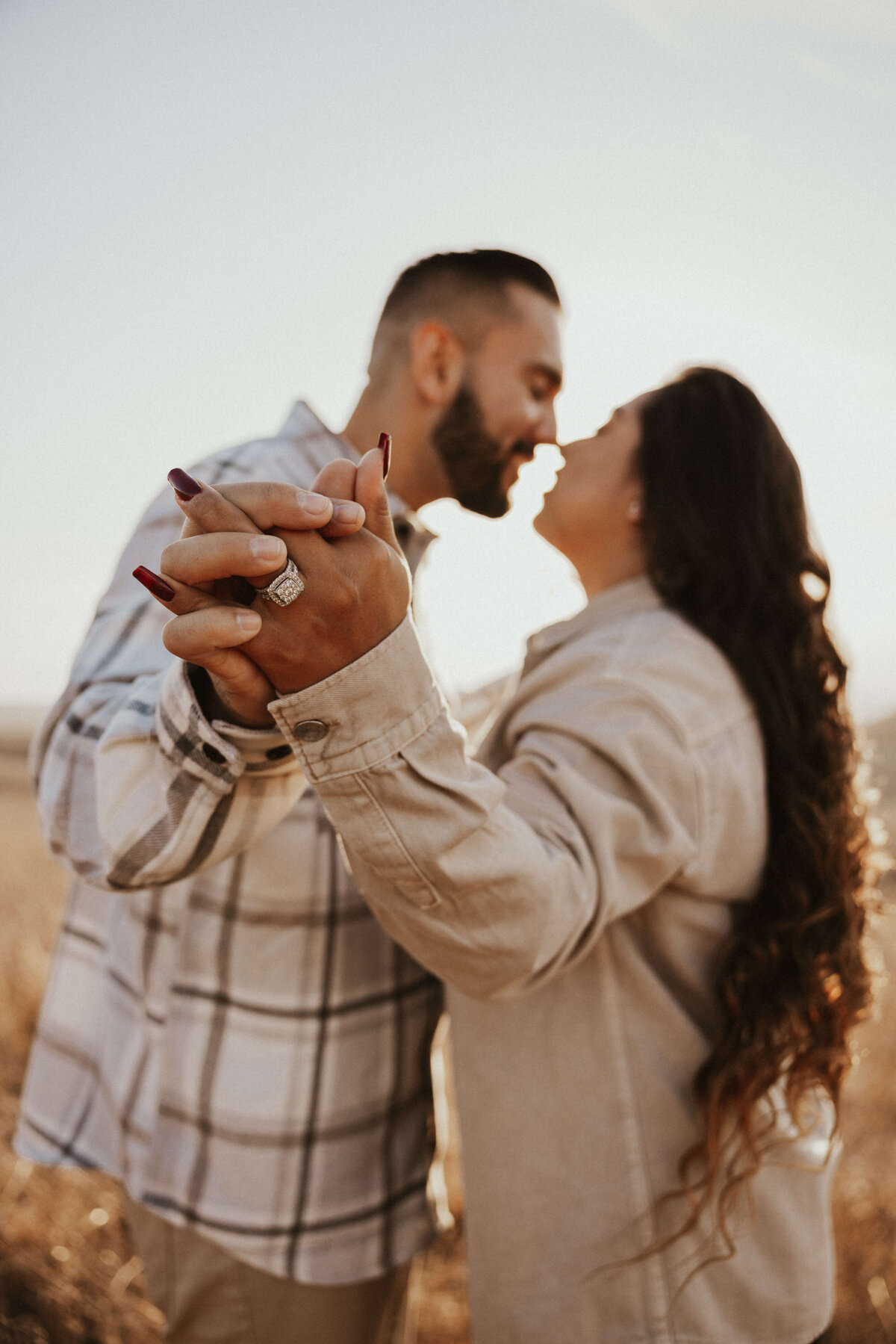 engagement-ring-open-field-couple-detail-shot