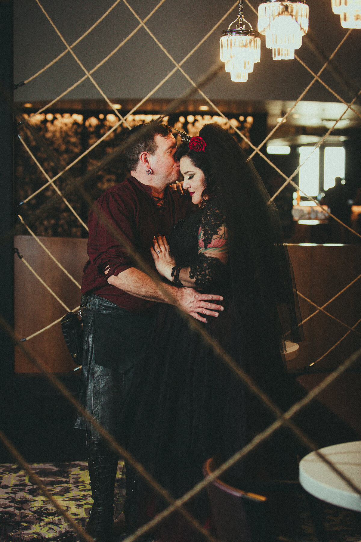 gothic bride and groom embrace savannah ga destination wedding breaking tradition