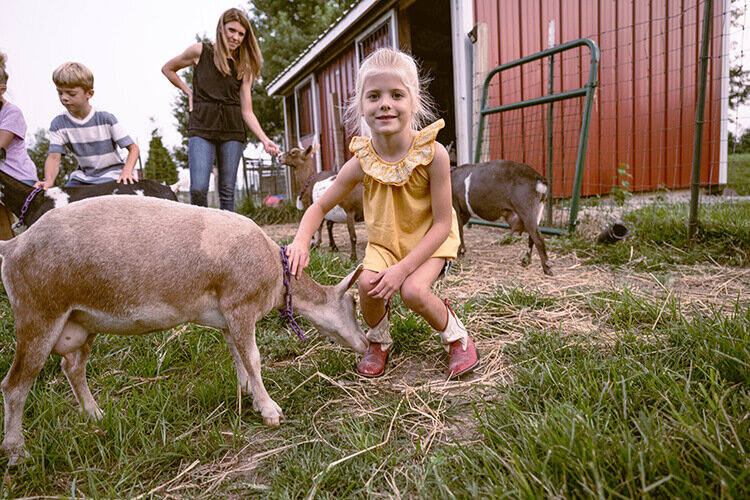 homestead-girl-with-farm-goat