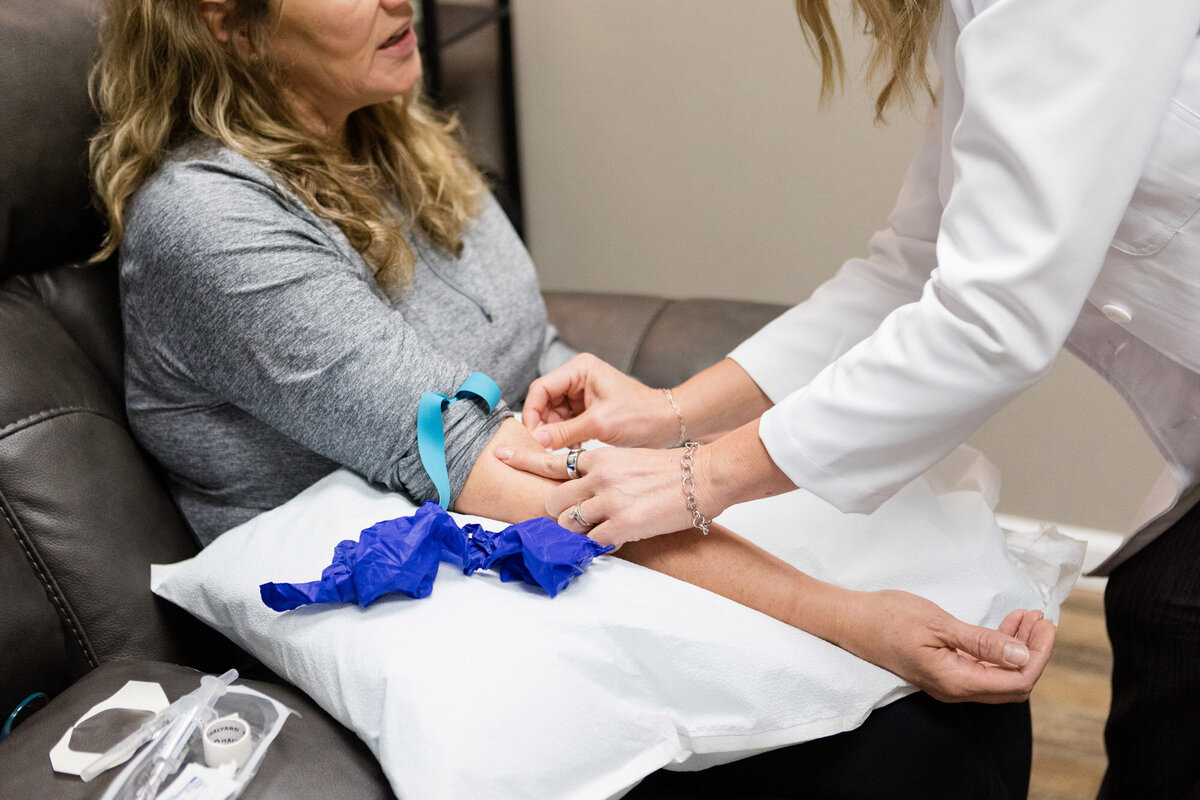 Nurse starting an IV in a patient's arm
