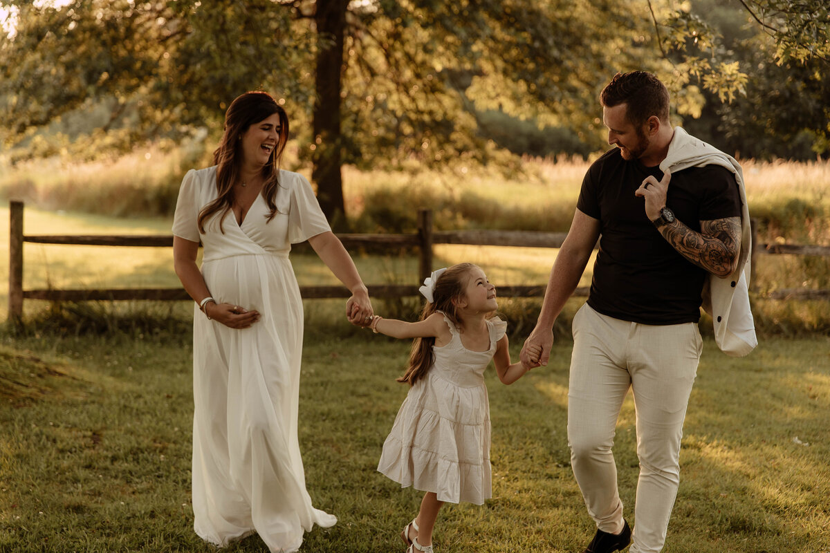 A family posing for their family photo in a park in Central, New Jersey