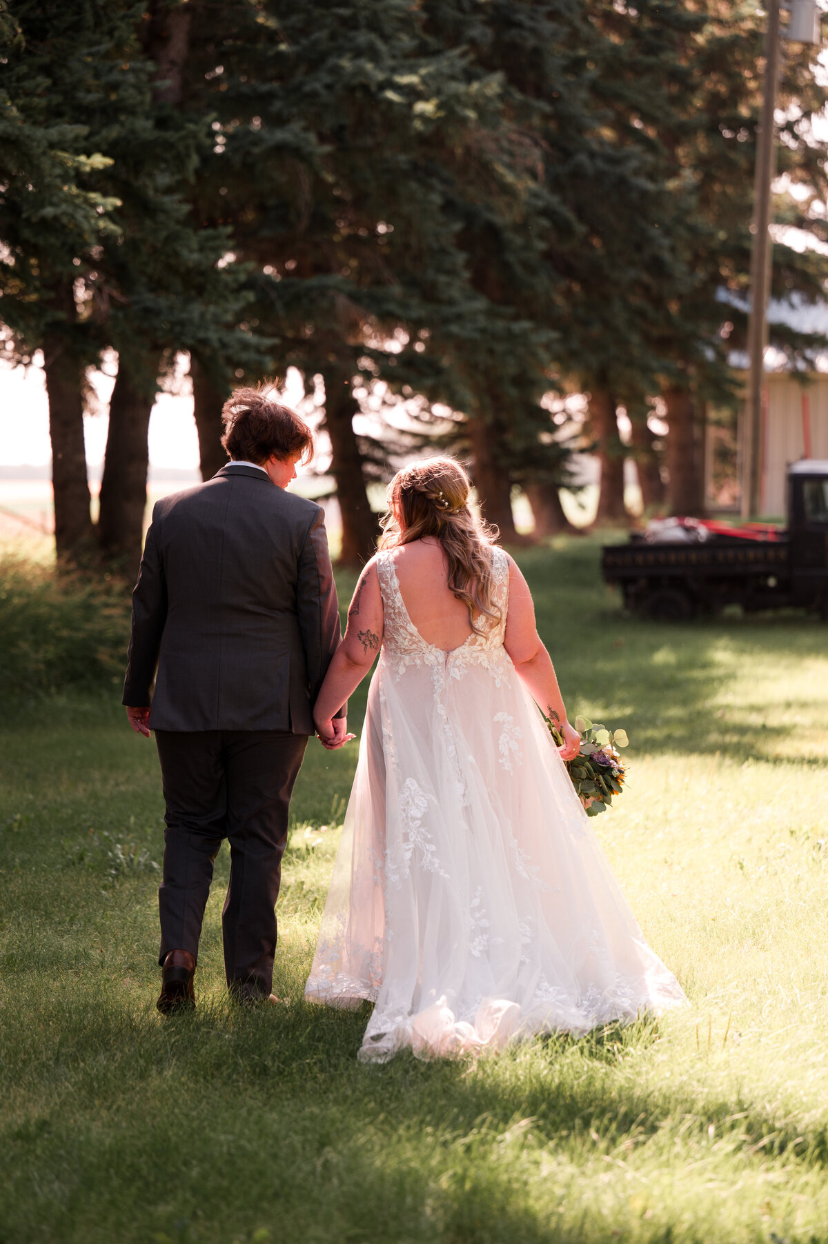 Falkenberg Weddings photo at the venue of the bride and groom walking into a field. 