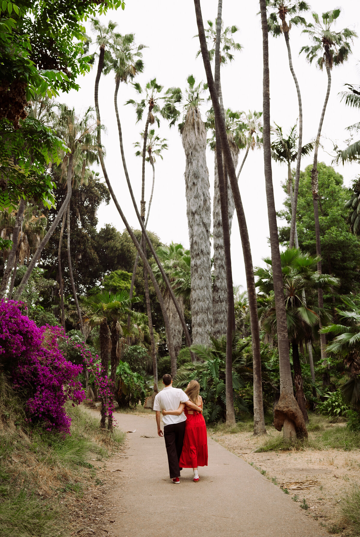 couple walking down nature trail in park