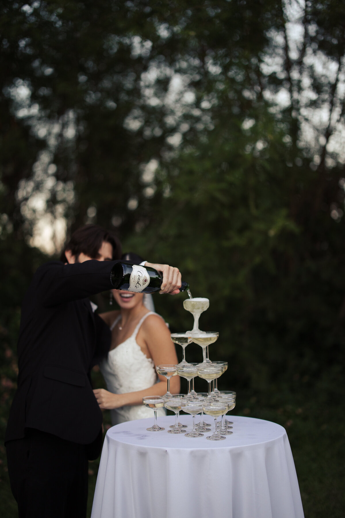 Bride and groom pouring champagne