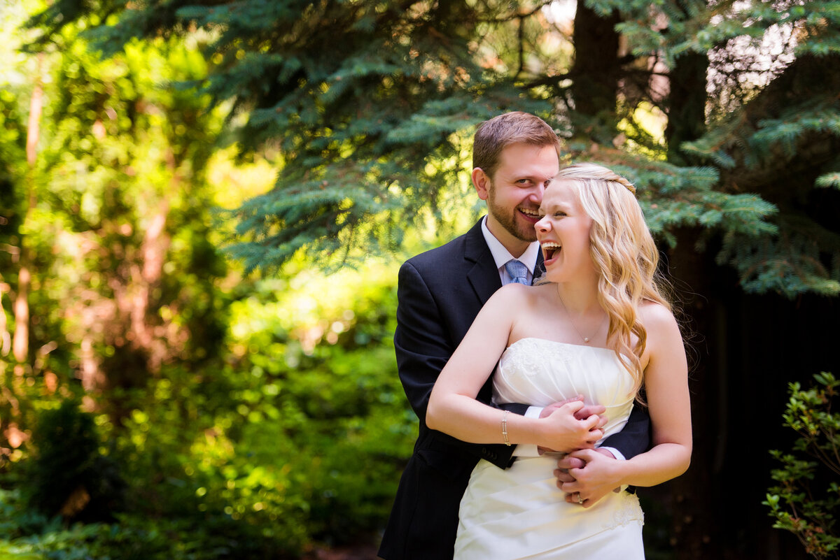 happy couple posing for wedding picture in the greenery at the Hyeholde
