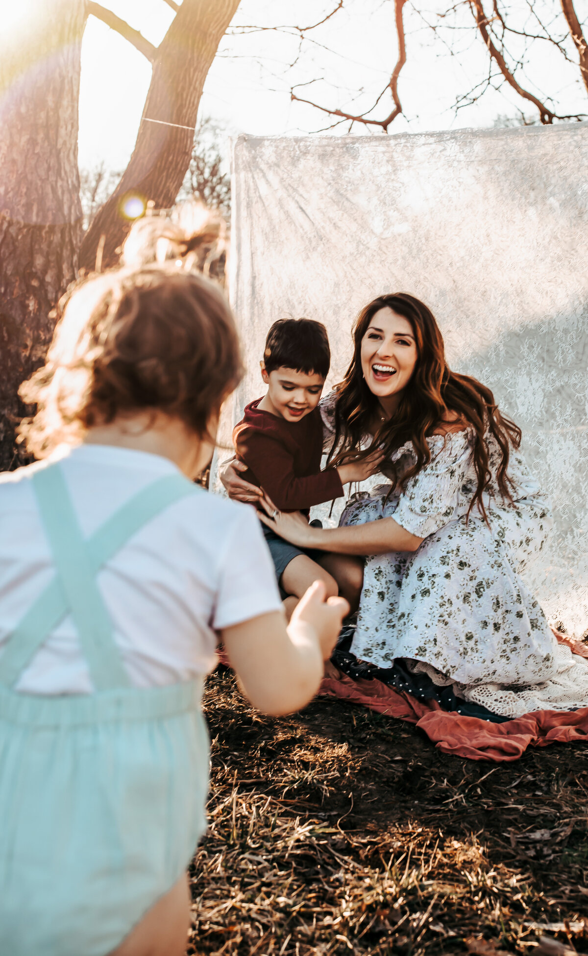 mom playing with kids at the park in Toledo
