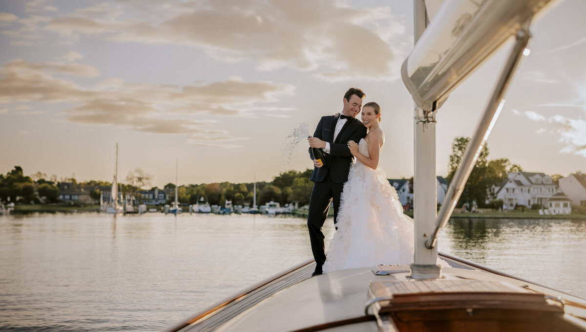 elite-bride-and-groom-toasting-champagne-on-chesapeake-sailboat