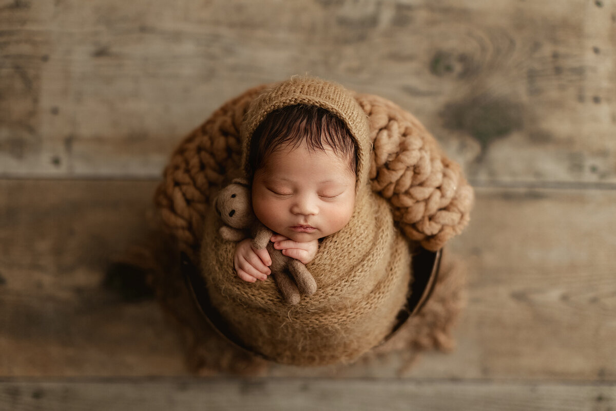 baby boy wrapped for his newborn photos in our denver photography studio