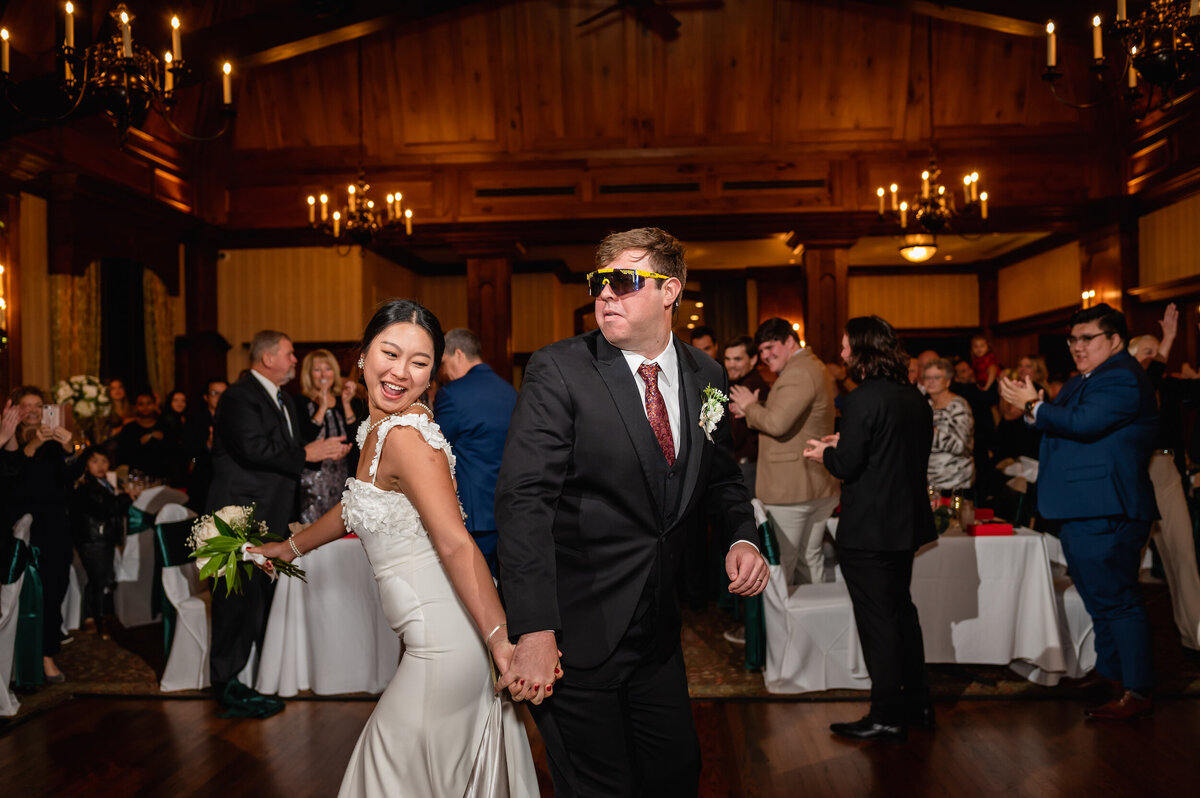 A bride and groom bump butts during their wedding reception at Cog Hill Country Club
