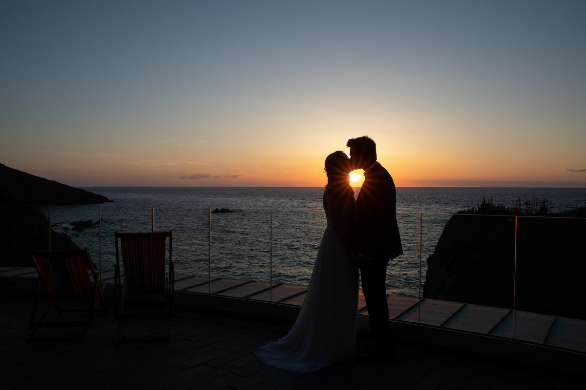 Tunnels Beaches wedding venue in Devon Sunset kiss on roof terrace