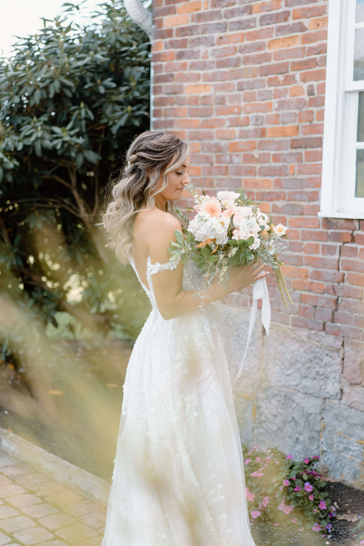 Bride holding bouquet of pale florals