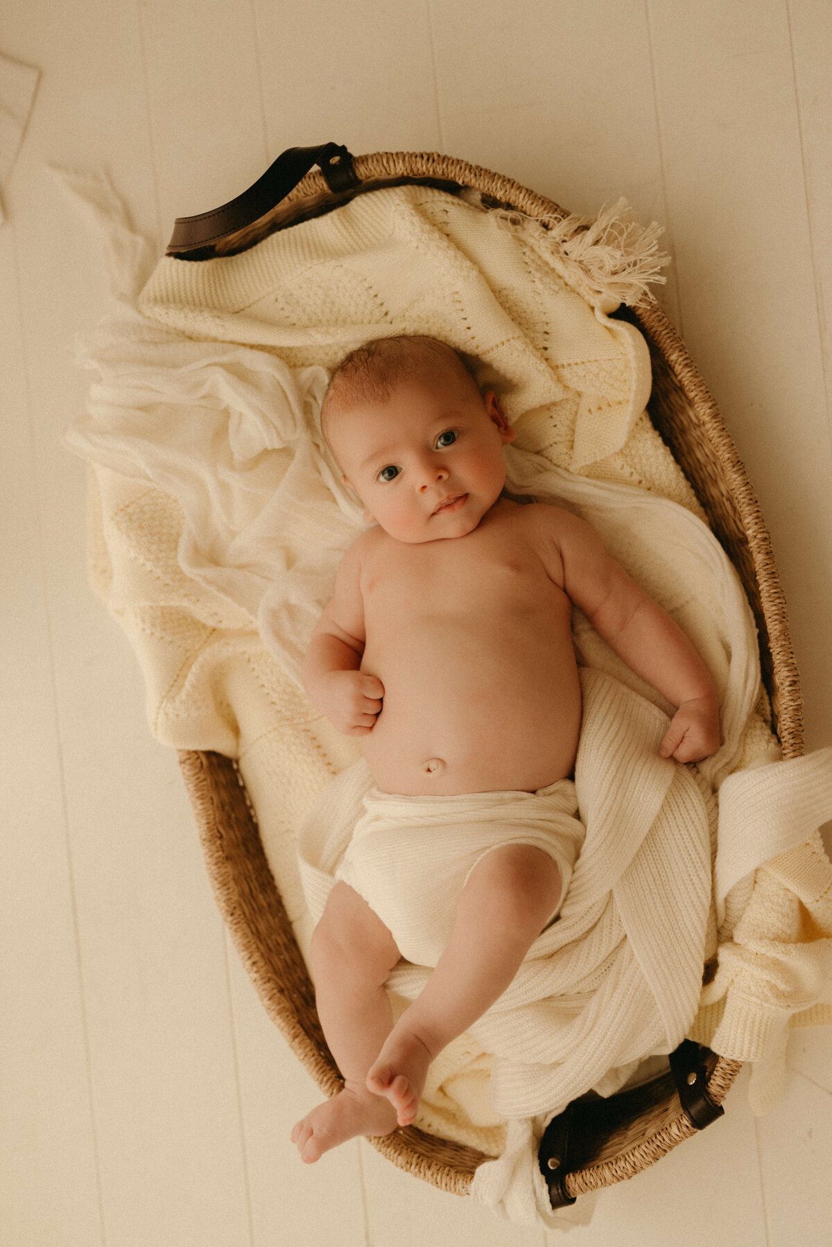 Minimalist baby photo of 6-week-old wrapped in soft knit during Nashville newborn session