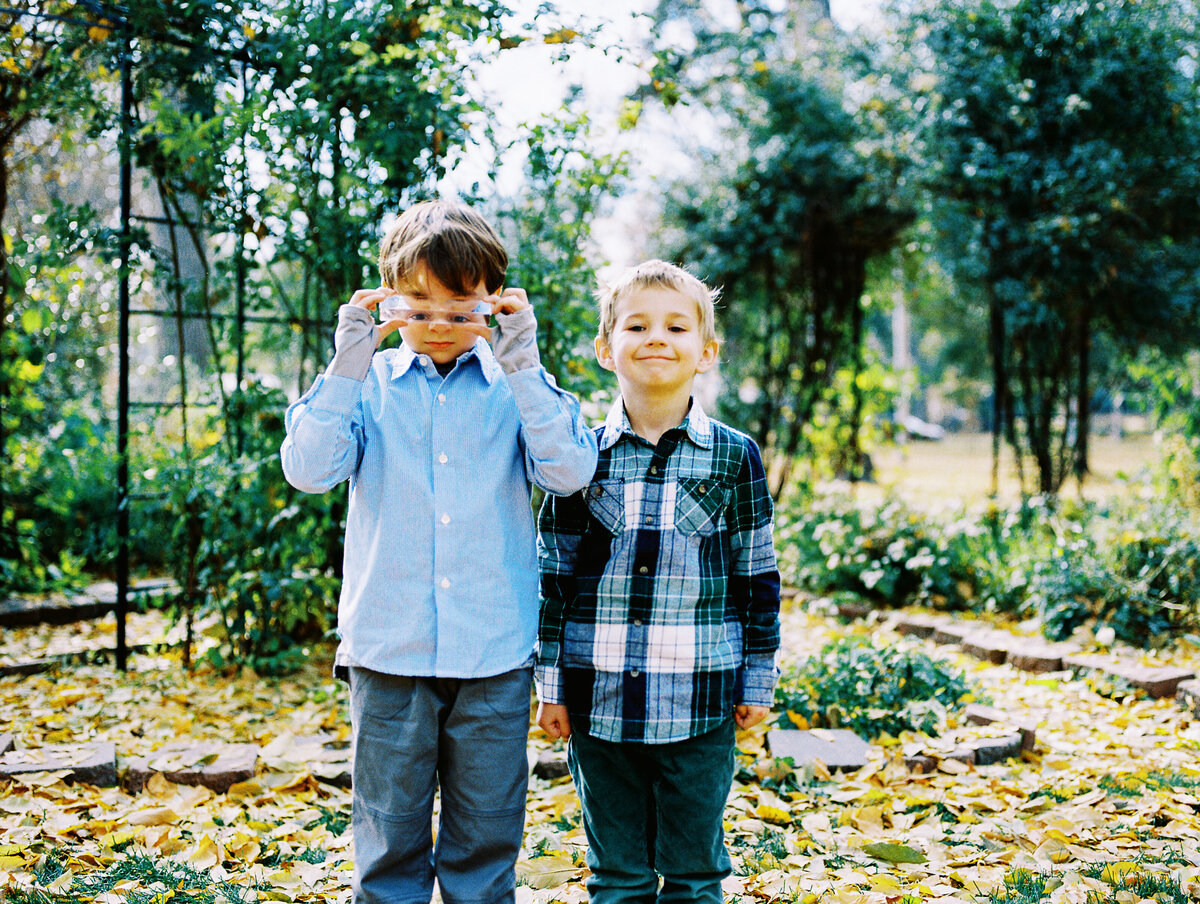 two boys stand next to each other on a fall day in longmont, colorado