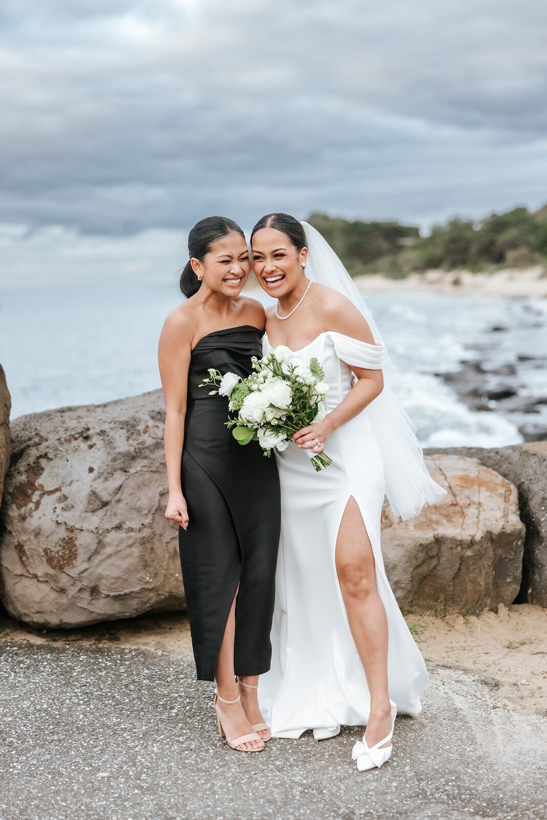 Bride and her bridesmaid on the beach at a wedding