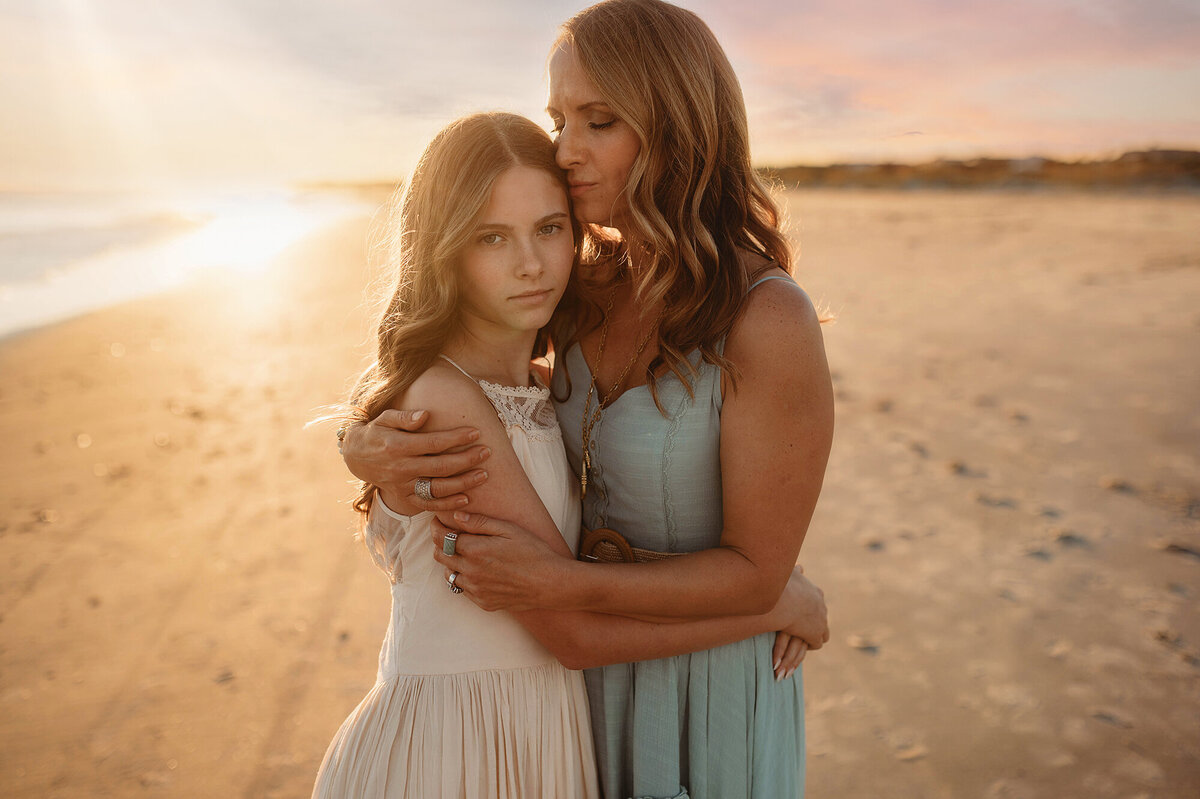 Mother kisses her daughter during Beach Pictures in Isle of Palms.