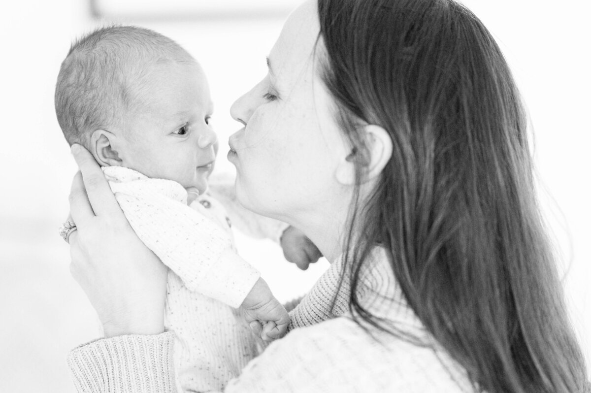 Newborn being kissed by his mom taken in Sutton, MA 