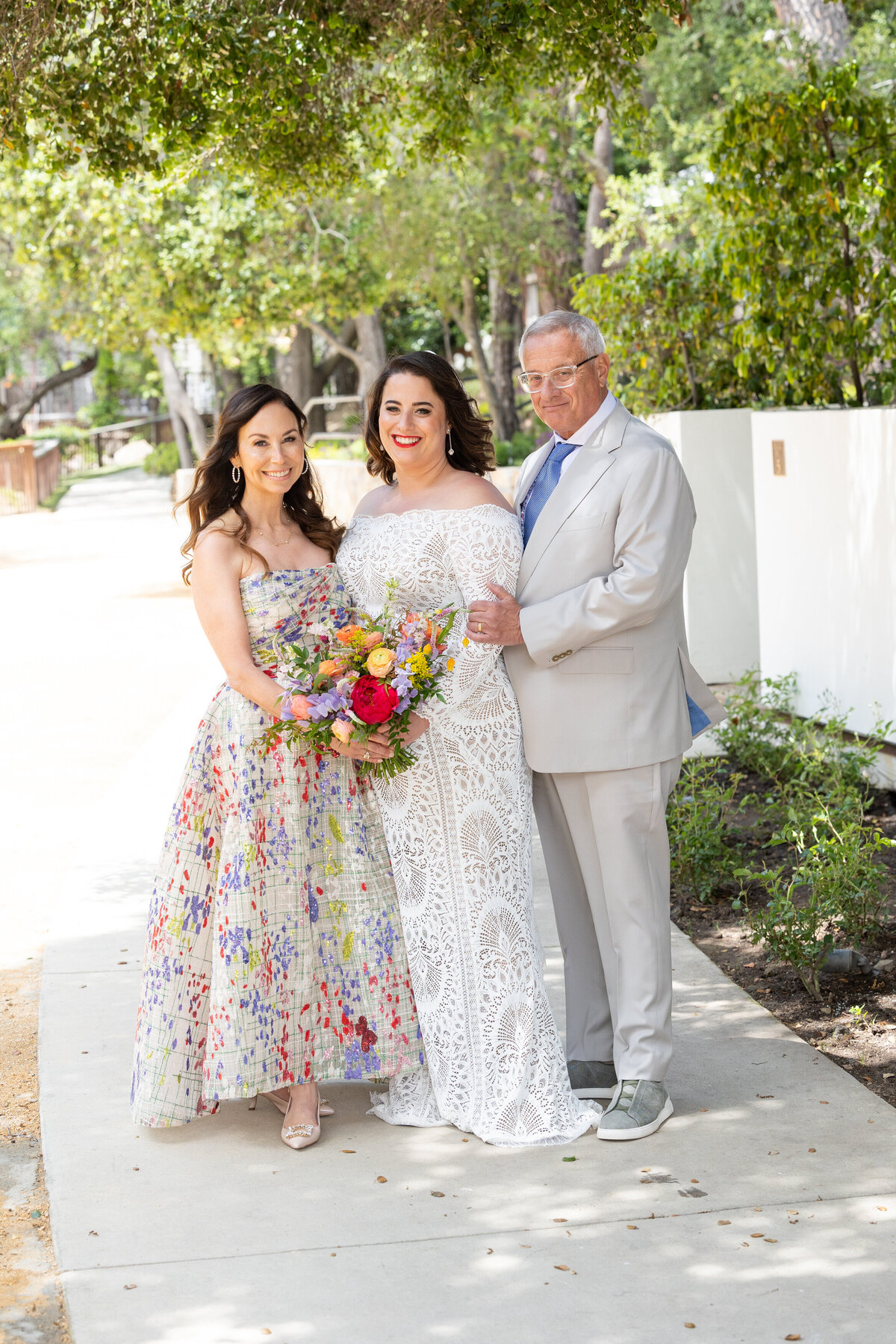 A man and woman standing on either side of a bride