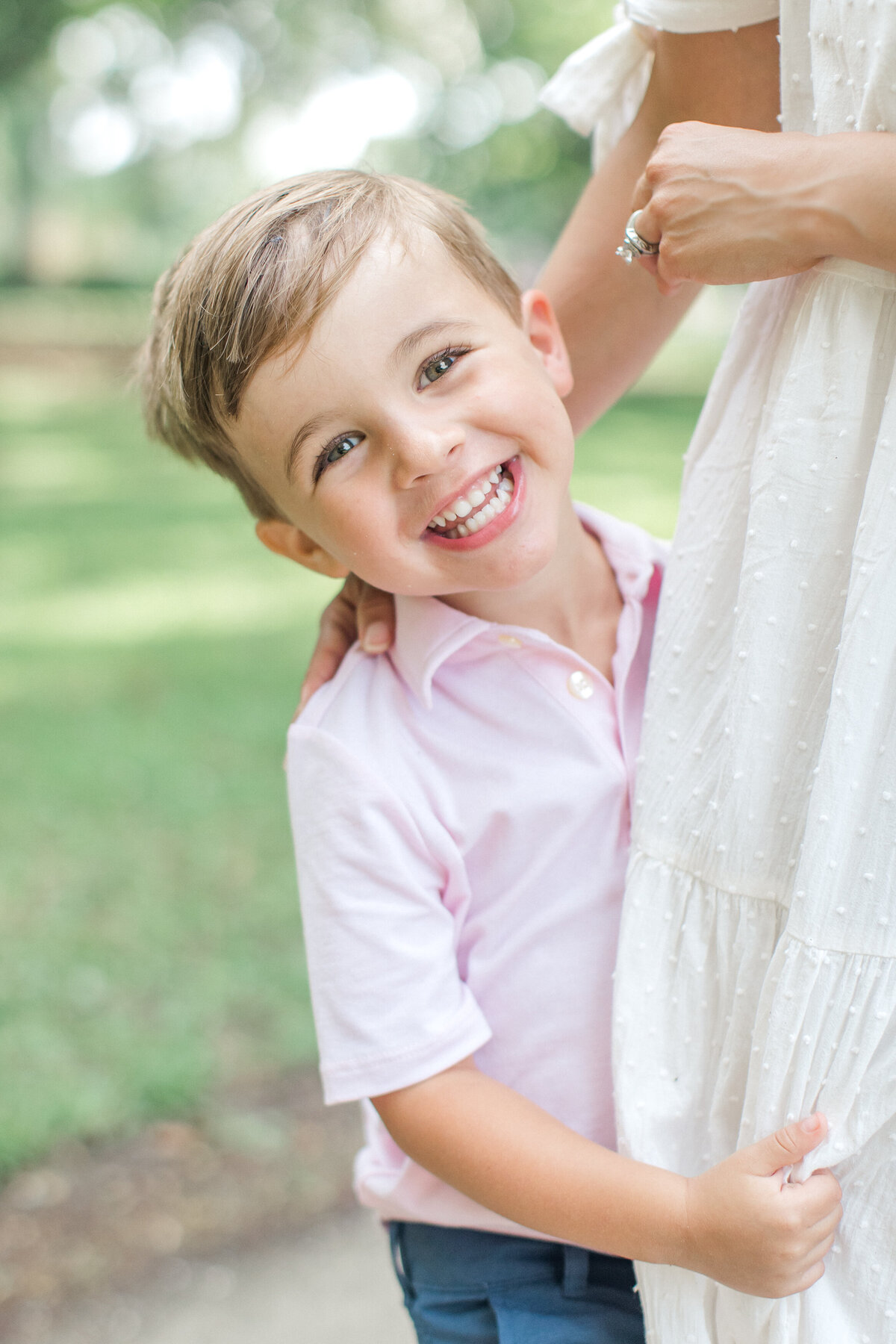 Boy smiles for family portrait with Karen Schanely
