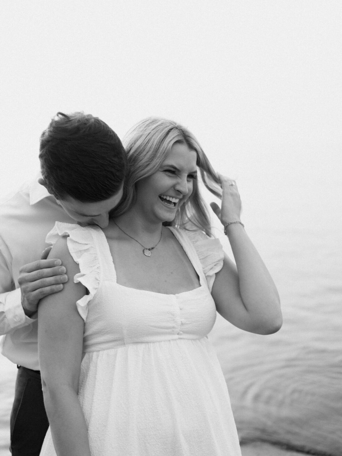 Outdoor engagement session with scenic lake views on a Cleveland beach.