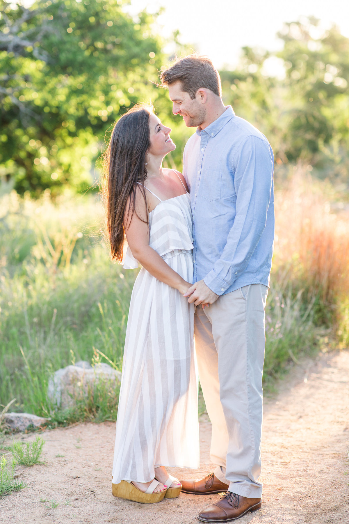 Engagement photos of couple embracing at Enchanted Rock; Fredricksburg, Texas