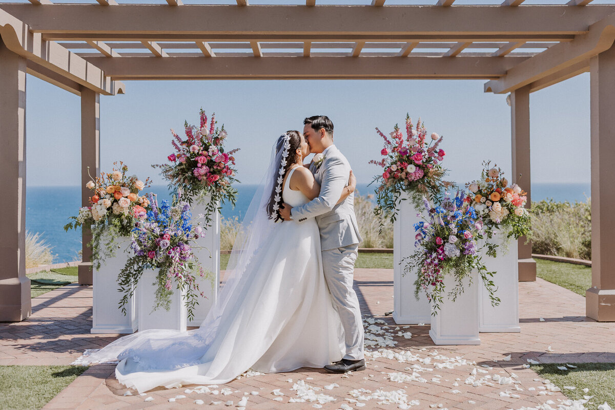 Terrranea resort wedding creremony on the Catalina POint wedding lawn with flower columns