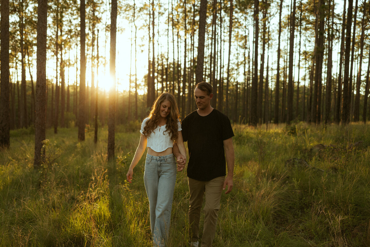 Couple posing for portraits in a forest.